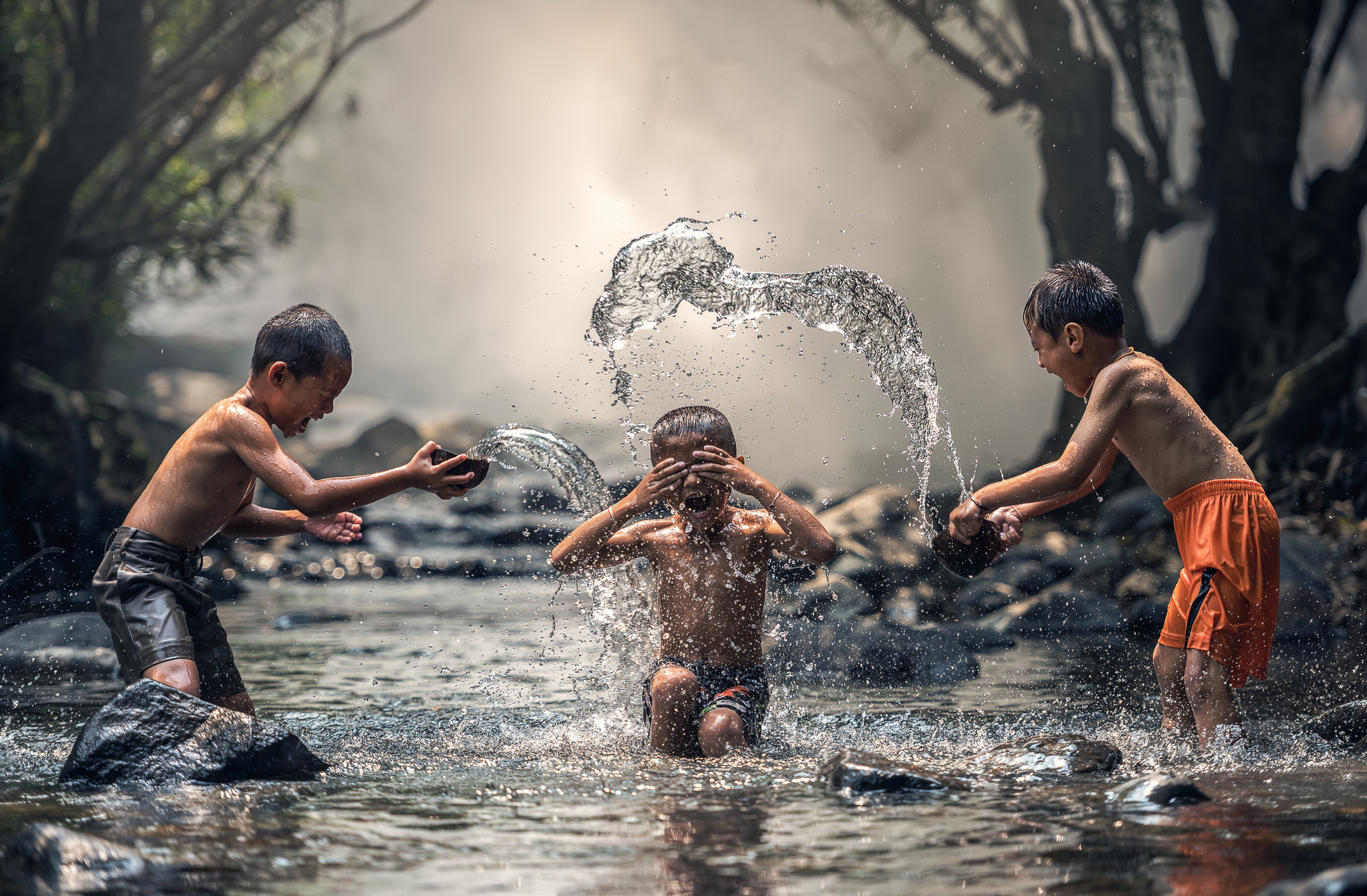 Three Boys Playing with Water in the River